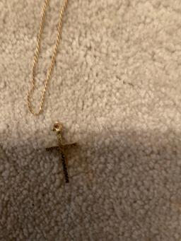 Golden necklace with golden cross with Jesus on it