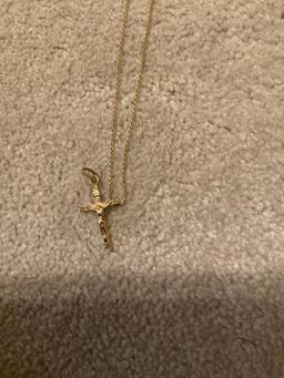 Golden necklace with golden cross with Jesus on it