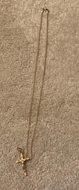 Golden necklace with golden cross with Jesus on it
