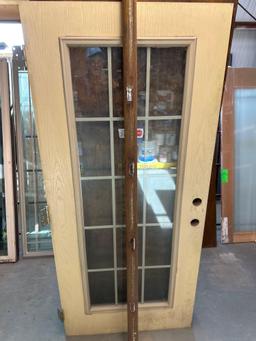 Glass door with wooden frame around it 36 x 79 1/4 in...
