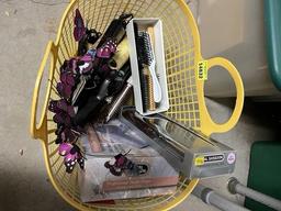 Basket of curling irons, blow dryer, and combs