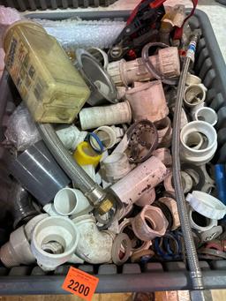 Tote with PVC fittings, supply lines, and other various plumbing items