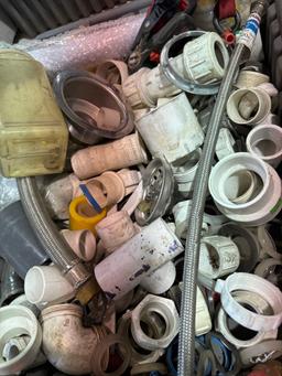Tote with PVC fittings, supply lines, and other various plumbing items