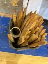 trash can with wood yard stakes