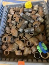 Tote with various gas pipe fittings