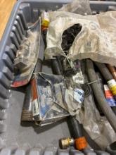 Bag of half pipe clamp with nail, black pipe, supply lines, and other misc items