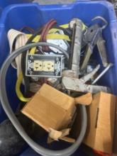 Tote contains caulking guns, electrical plugs, electrical cord for dryer, and other various items