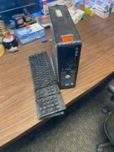 Dell computer tower and two keyboards