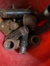 Bucket of mixed black pipe fittings