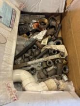 Miscellaneous pipe fittings, wrenches, piece of PVC pipe
