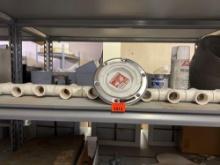 Contents on shelf, which include PVC HVAC 22s, white spray paint, PVC cement, pipe, thread sealant,