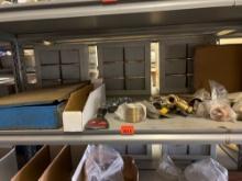 Contents of shelf, which includePart of a tankless hook up kit, putty, knife, copper fittings, a