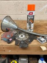 Orange marking spray, funnel, screws, grinding wheel, wire brush, washers, and other various blades