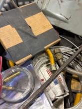 Tote contains gas supply lines, plastic anchors, capacitors, and other various plumbing items