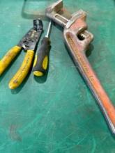 Pipe wrench, wire stripper and screwdriver