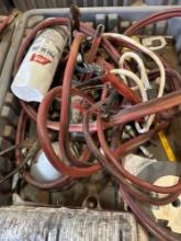 Tote contains jumper cables, spray paint, hand tools, grinder wheel and much more