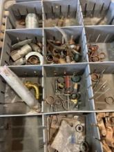 Various items such as pex rings, fittings, screwdriver, drill bits and other items