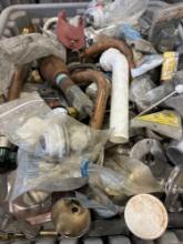 Tote with various plumbing items