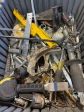 Tote with measuring tape, pipe bender, hole saw bits, and multiple other items