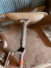 Tractor seat with attachment