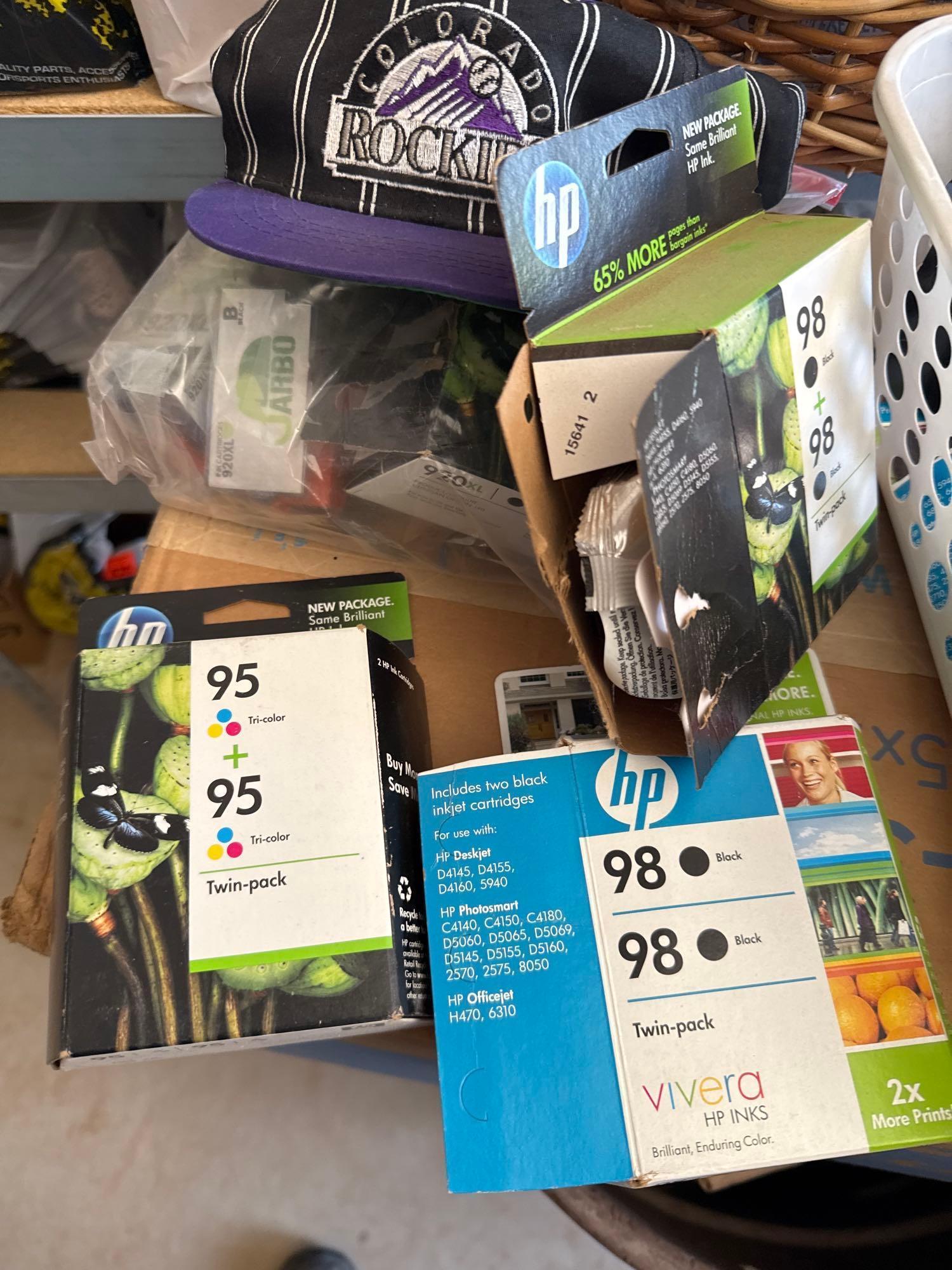 HP printer cartridges and a Colorado Rockies hat