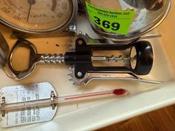 Small sifter, thermometers, egg separators, wine bottle opener in tray