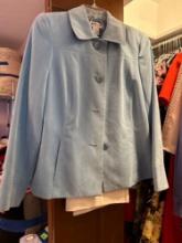 Blue and white pant suit, brown and white top, green jacket, white and black skirt suit, green skirt