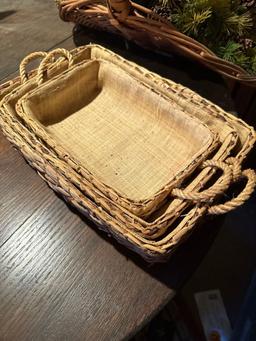 Several woven baskets, greenery with pine cones, duck pillow and more