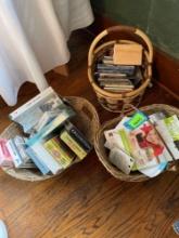 3 woven baskets with VHS tapes, cassettes, and CDs, see photos for titles and artists