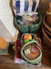 Woven baskets, organizing tray, decor items, aluminum trays, toiletries bag with items inside,