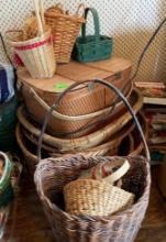Variety of woven baskets and picnic basket with paper goods inside