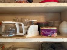3rd shelf up, contents on shelf, Small kitchen scale, measuring cup, molds, and more