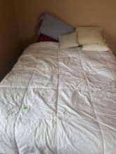 Queen bed with comforters and pillows