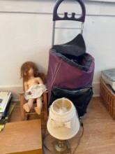 Vintage doll in rocking chair, wooden filing box, small lamp, work cart on wheels and zip binder