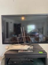 Emerson 32 inch flat screen tv, plastic tv stand, RCA antenna, remotes, surge master power strip,