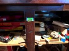 Contents on shelf, games and old phone