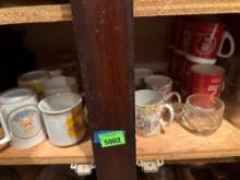 Contents on shelf, OU mugs, floral mugs, teddy bear mugs