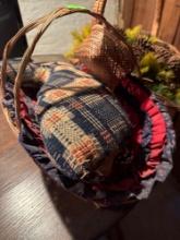Several woven baskets, greenery with pine cones, duck pillow and more