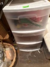 3 tiered plastic storage organizer with sewing items such as thread, needles, ribbon, sewing kits,