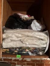 Everything on shelf: fabric, blanket more
