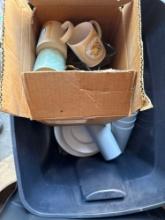 Tote wit ceramic coffee cups, bowls, plates white and tan dishes are a 4 piece of 4 place settings