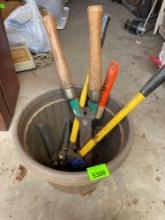 Several garden shears in plant bucket