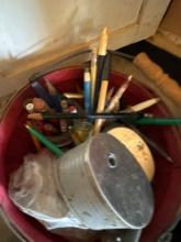 Basket with a pencil sharpener, pencils, and rope, metal tray and more