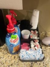 coffee creamers; plastic cups; stir sticks; sugar