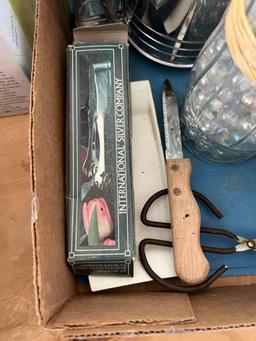 Box with a sifter, cookie cutters, flower vase, salt and pepper shakers, decorating tips and other