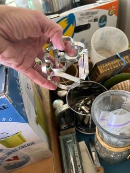 Box with a sifter, cookie cutters, flower vase, salt and pepper shakers, decorating tips and other