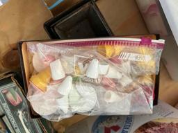 Box with a sifter, cookie cutters, flower vase, salt and pepper shakers, decorating tips and other