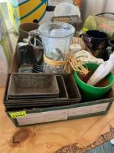 Box with a sifter, cookie cutters, flower vase, salt and pepper shakers, decorating tips and other