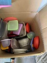Box full of plastic bowls and lids