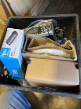 Marine radio cover, radio, and other miscellaneous items in tote
